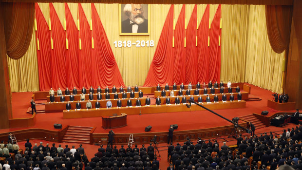 Participants stand as The Internationale is played in the Great Hall of the People to mark 200 years since the birth of Karl Marx.