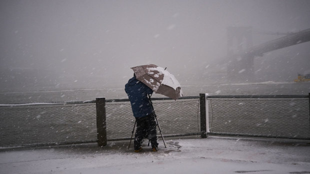 Snow falls at Brooklyn Bridge Park.