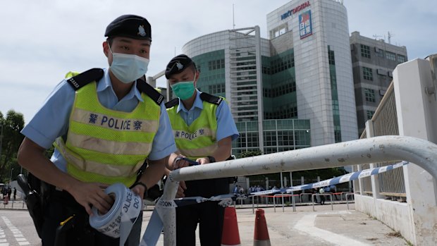 Hong Kong police tape up the entrance to the Apple Daily newsroom on Monday.