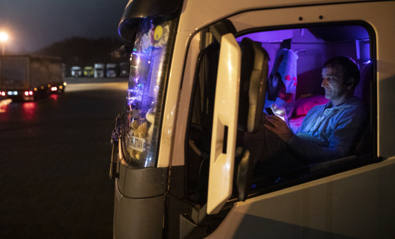 A Romanian lorry driver waits in his cab at Ashford lorry park as restrictions on travelling to the continent continue.