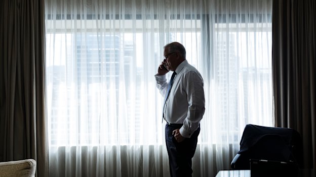 Scott Morrison on the phone to wife Jenny during a break in his Brisbane hotel room.