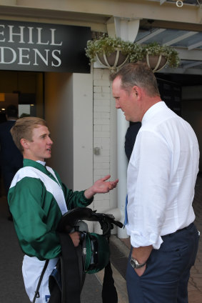 Job well done: Brock Ryan talks to trainer Michael Hawkes in the mounting yard.