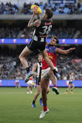 Collingwood highflier Jeremy Howe takes a grab over Brisbane at the MCG.