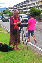 Filmmaker Robyn Hughan shooting footage for the documentary Journey Beyond Fear outside a Kuala Lumpur housing estate.