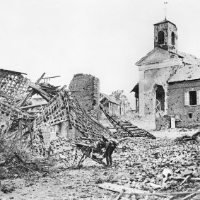 A soldier picks through the ruins of Chipilly village, France, on August 10, 1918, the day after the Chipilly Six had cleared the Spur.