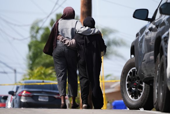 Two women embrace near the mosque in San Diego.