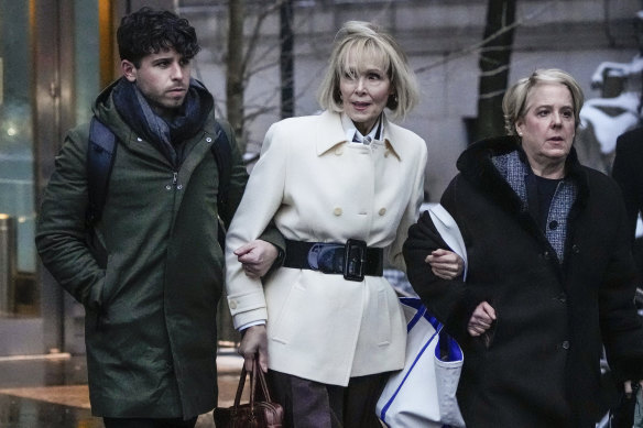 E. Jean Carroll, center, leaves Manhattan federal court following her defamation trial against former President Donald Trump. 