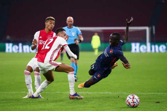 Awer Mabil of FC Midtjylland is fouled by Noussair Mazraoui of Ajax.