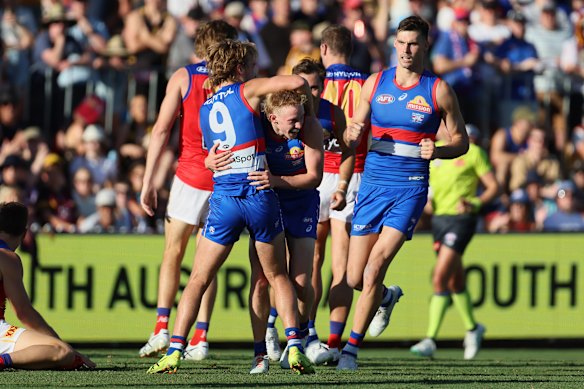 The Bulldogs’ Josh Dolan (centre) celebrates his first AFL goal.