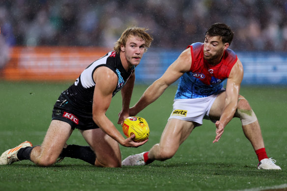 Jason Horne-Francis looks to get the ball away as Jack Viney moves in.