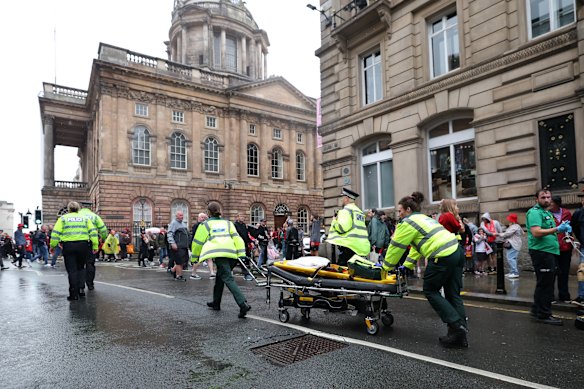 Emergency services at the scene after a car drove into a parade celebrating Liverpool’s Premier League soccer title.