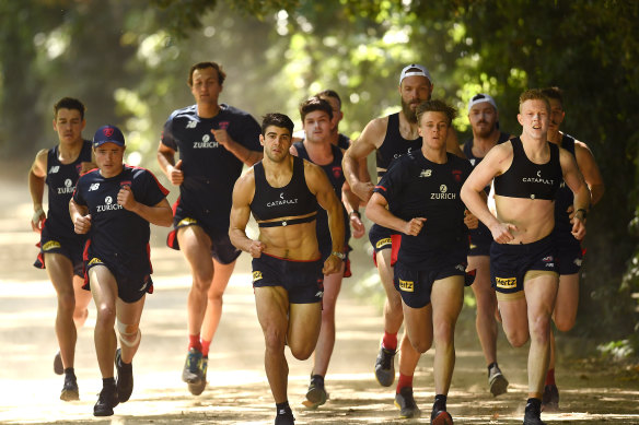 Christian Petracca and Clayton Oliver lead the Demons in a November training session.