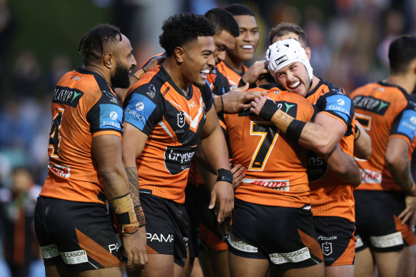 Wests Tigers players celebrate a try during their stirring win over Gold Coast Titans at Leichhardt Oval on Saturday.