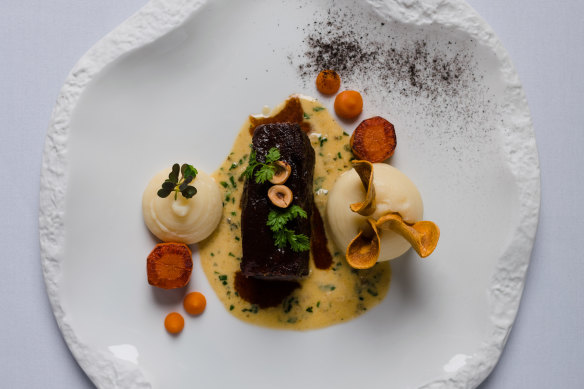 The angus beef cheek, pomme puree, slow-baked celeriac, hazelnuts, oyster leaf and cafe de paris sauce at Courgette.