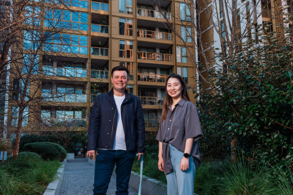 Residents Thomas Pospieszny and Nancy Chen outside their building, a Mirvac build-to-rent property at Sydney Olympic Park.