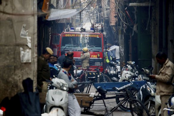 A fire truck attends the site of a deadly fire in New Delhi on Sunday.