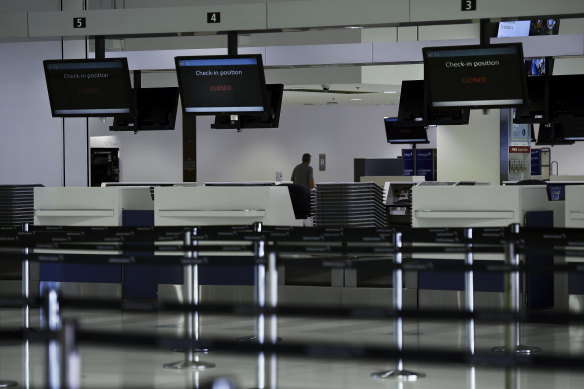 Closed check-in counters in the departure terminal at Sydney international airport.