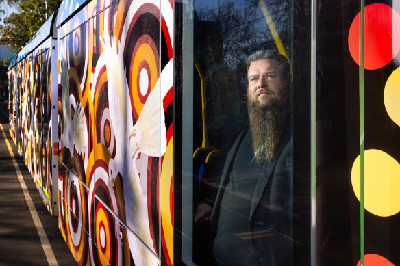 “I love taking it out here and putting it on the streets”, says Tiriki Onus, inside the new art tram reproducing his father’s 1991 original work. 