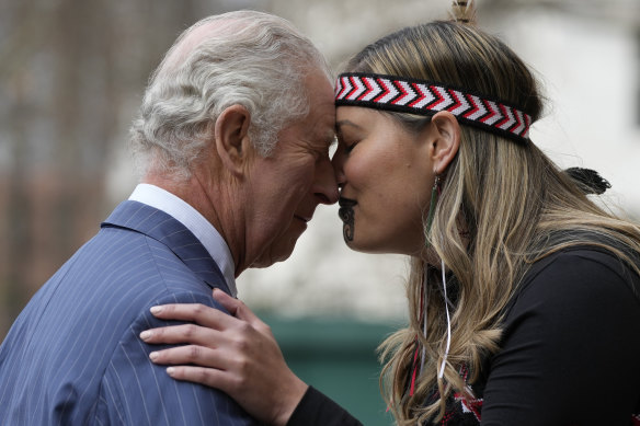 Britain’s King Charles III is greeted by a member of a Maori group as he arrives to attend the annual Commonwealth Day service at Westminster Abbey.