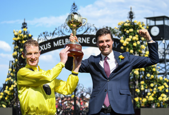 Winning jockey Mark Zahra and Sam Freedman with the Cup after Freedman and his father Anthony trained Without A Fight.