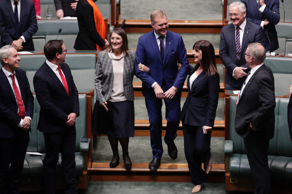Tony Smith is "dragged" to the speaker's chair by Labor's Maria Vamvakinou and Liberal MP Lucy Wicks.