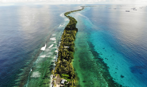 A strip of land between the Pacific Ocean, left, and lagoon in Funafuti, Tuvalu. The low-lying South Pacific island nation of about 12,000 people has been classified as ‘extremely vulnerable’ to climate change by the UN.