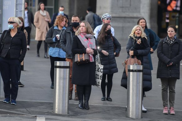 Commuters coming out of Flinders Street Station on Friday morning. 