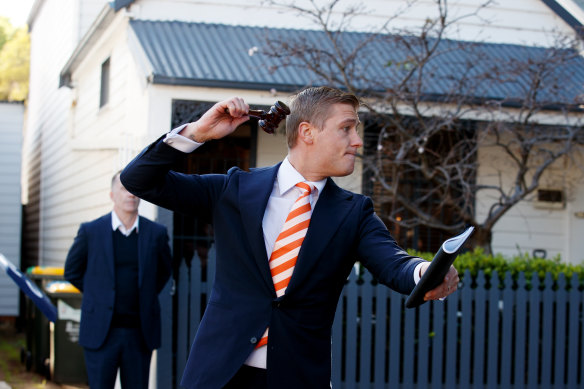 Auctioneer Jake Moore prepares to sell the Balmain home for $1,686,000.