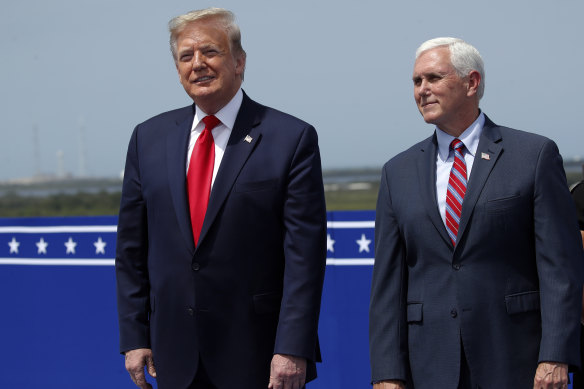 President Donald Trump stands with Vice-President Mike Pence as they wait to view the SpaceX flight to the International Space Station.