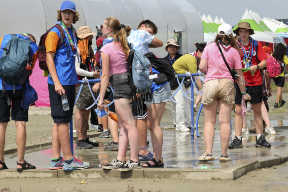 World Scout Jamboree attendees cool off from the heat by soaking in water at a coastal campsite in South Korea.