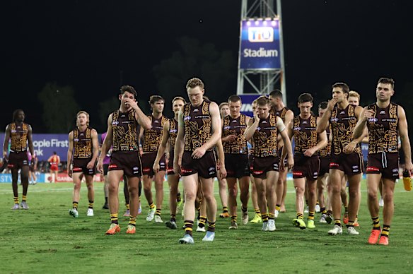 Hawthorn walks off the ground after losing to the Suns.