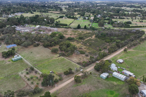 The small bush block on a bend in the highway is the subject of a VCAT dispute between residents and a religious group that seeks to build a temple there.