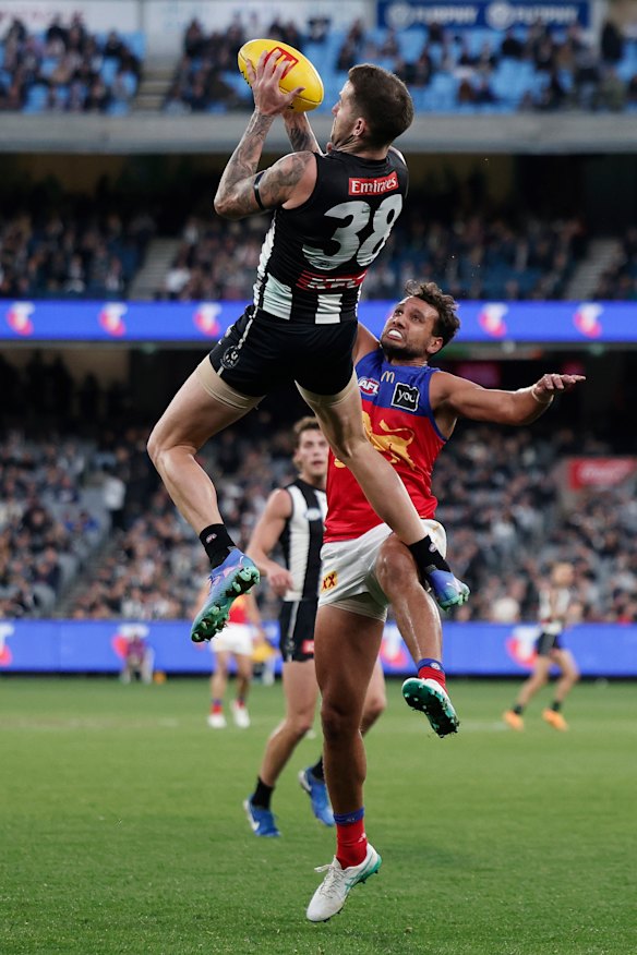 Collingwood highflier Jeremy Howe takes a grab over Brisbane at the MCG.