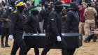 A coffin containing the body of Ariel Bibas is taken to Red Cross representatives in Khan Younis in the Gaza Strip on Thursday.