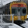 A V-set train travels through the Blue Mountains in winter.