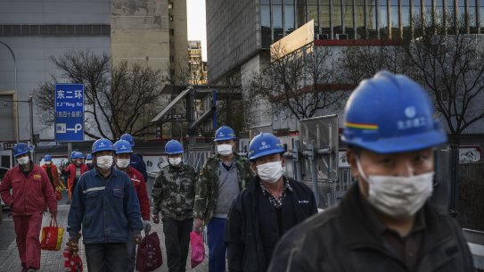 Construction workers finish their shift in Beijing.