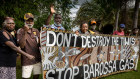 Tiwi Islanders holding a banner they made to protest the Barossa gas project.