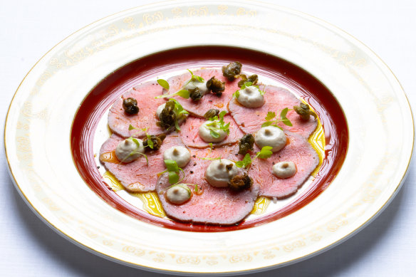 Rosy vitello tonnato (poached veal with tuna mayonnaise) is dotted with fried capers.