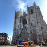 Fire fighters brigade work to extinguish the blaze at the Gothic St. Peter and St. Paul Cathedral, in Nantes, western France,
