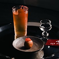 Sake cocktail with an ikura (salmon roe) doughnut.