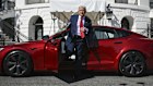 President Donald Trump steps out of a red Model S Tesla vehicle on the South Lawn of the White House Tuesday, March 11, 2025, in Washington. (Pool via AP)