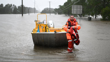 A member of the State Emergency Services prepares to take to floodwater on February 27 in Logan.