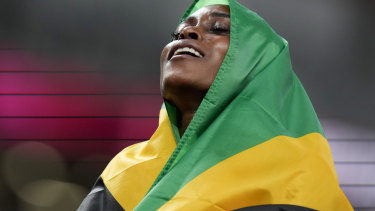 Elaine Thompson-Herah, of Jamaica, celebrates gold. 