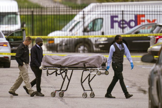 A body is taken from the shooting scene at the FedEx facility in Indianapolis.