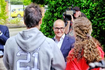 Education Minister James Merlino speaks with students at McKinnon Secondary College last week. The education union says Andrews government MPs are no longer welcome at government schools. 