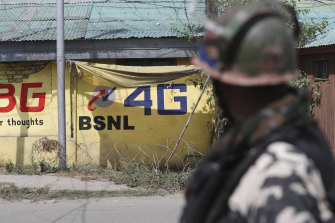 An Indian paramilitary soldier keeps guard outside the main telephone exchange building in Srinagar, Indian controlled Kashmir during the 18-month ban on high speed internet services.