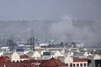 Smoke rises from an explosion outside Kabul airport on Thursday.