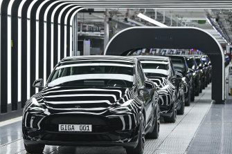 Model Y electric vehicles stand on a co<em></em>nveyor belt at the opening of the Tesla factory at the Gigafactory Berlin-Brandenburg in Grünheide, Germany, in March. 