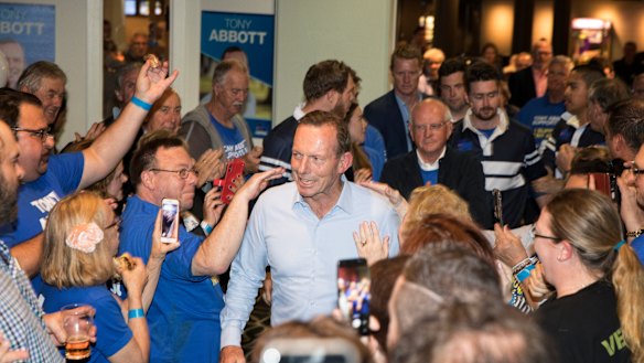 Supporters commiserate with Tony Abbott at Manly Leagues Club on election night. 