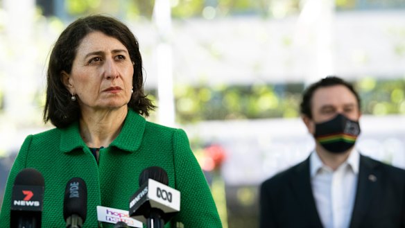 NSW Premier Gladys Berejiklian and Tourism Minister Stuart Ayres on Friday. Ayres expects Local Government Areas will no longer be used to mark boundaries of concern once a 70 per cent vaccination is achieved.